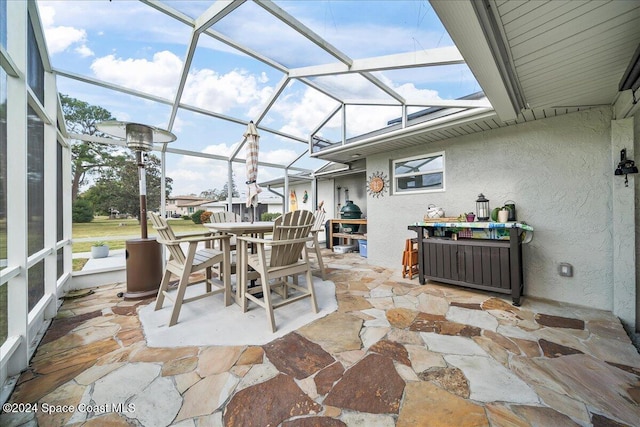 view of patio with glass enclosure