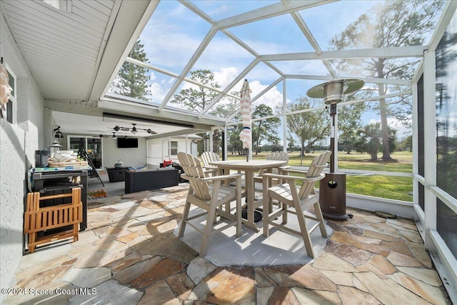 sunroom featuring vaulted ceiling