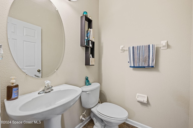 bathroom with toilet and sink