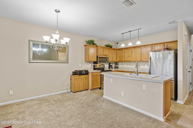 kitchen with a center island with sink, sink, decorative light fixtures, and stainless steel appliances