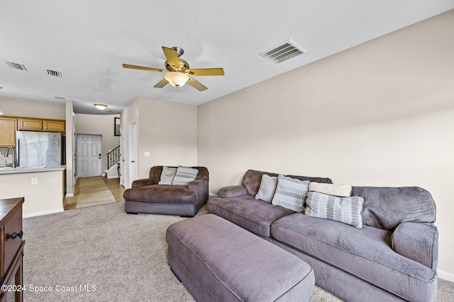 living room with light carpet and ceiling fan