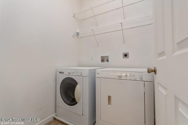 clothes washing area featuring washer and clothes dryer