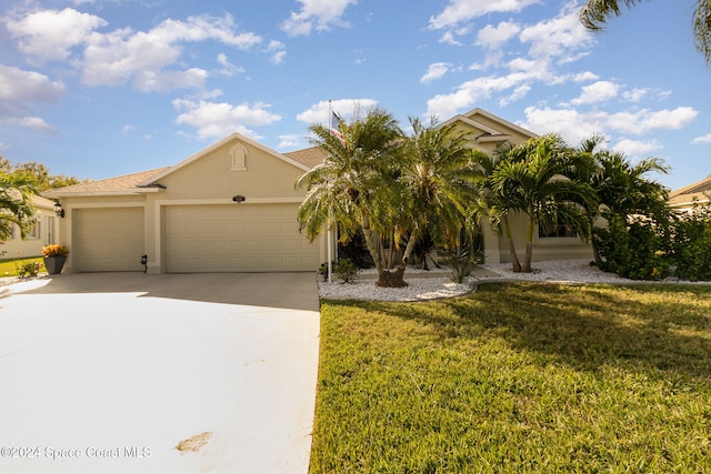 view of front of property with a front yard and a garage