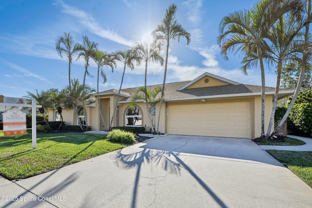 view of front of house with a garage and a front yard