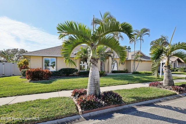 ranch-style home with a front lawn