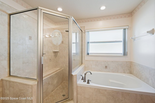 bathroom featuring shower with separate bathtub