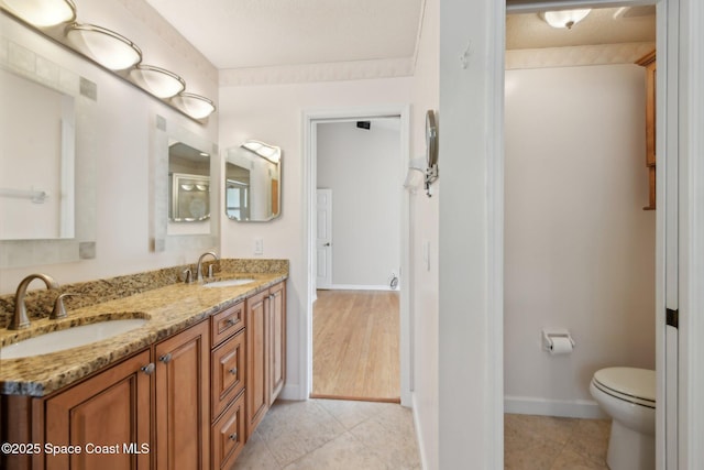 bathroom with tile patterned floors, vanity, and toilet