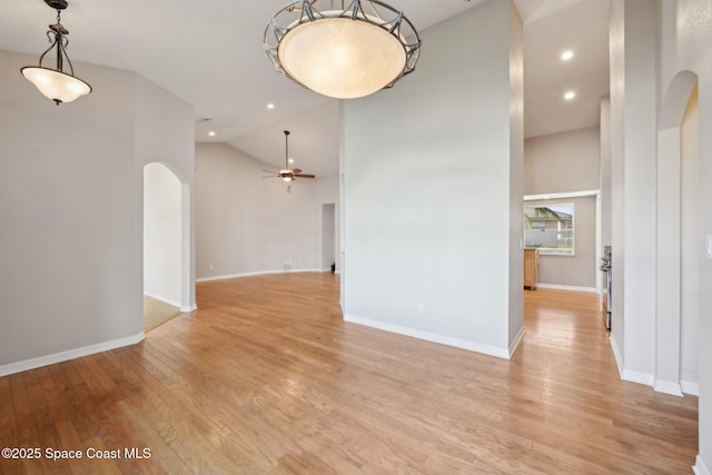 unfurnished room with ceiling fan, light hardwood / wood-style flooring, and high vaulted ceiling