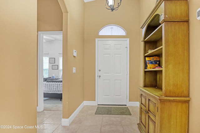 entrance foyer with light tile patterned flooring and lofted ceiling