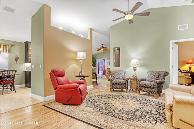 living room featuring high vaulted ceiling, hardwood / wood-style flooring, and ceiling fan