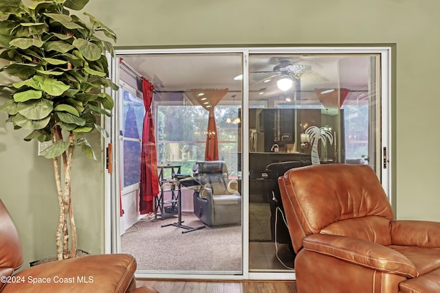 interior space with ceiling fan