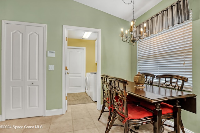 tiled dining room featuring separate washer and dryer and an inviting chandelier