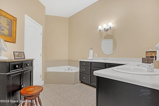 bathroom with vanity, tile patterned flooring, and tiled tub