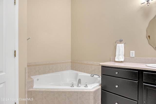 bathroom with a relaxing tiled tub and vanity