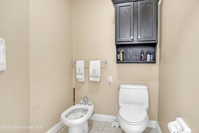 bathroom featuring a bidet, tile patterned flooring, and toilet