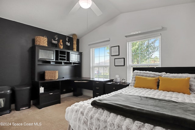 carpeted bedroom with ceiling fan, multiple windows, and lofted ceiling