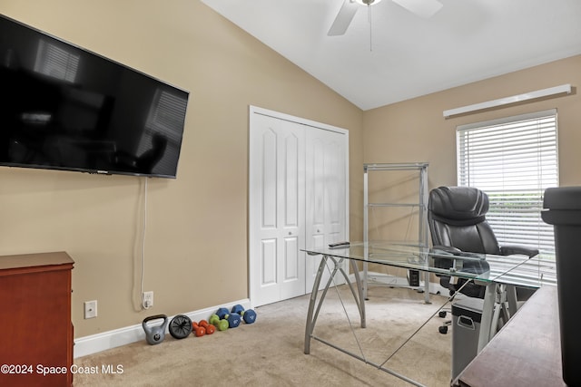 office featuring vaulted ceiling, light carpet, and ceiling fan