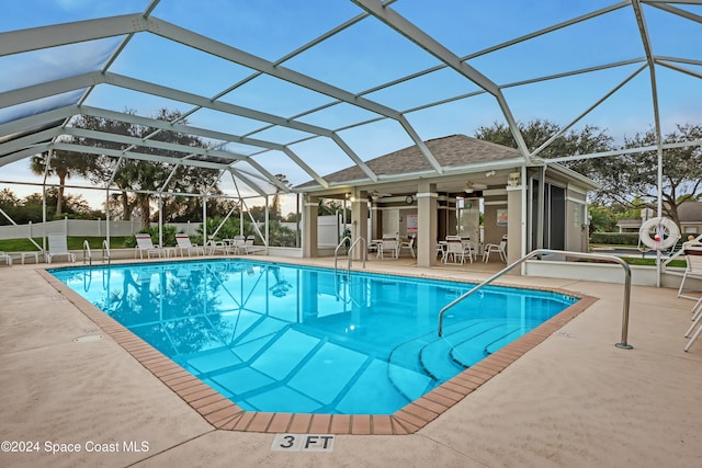 view of pool with a patio, a lanai, and ceiling fan