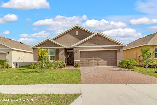 view of front of property featuring a garage and a front lawn