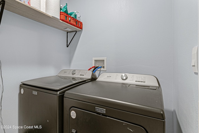 washroom with washing machine and clothes dryer