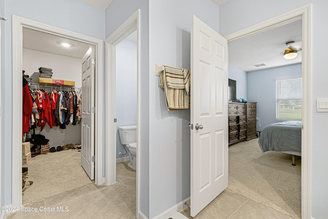 hallway featuring light carpet