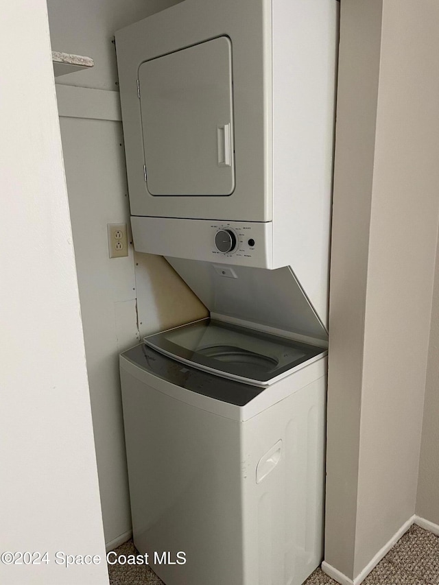 laundry room with stacked washer / drying machine