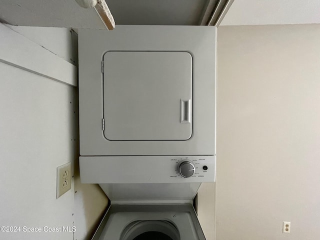 washroom with stacked washer / drying machine