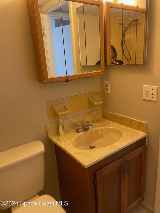 bathroom featuring vanity and toilet