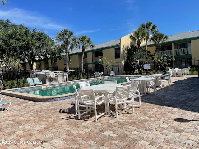 view of swimming pool with a patio