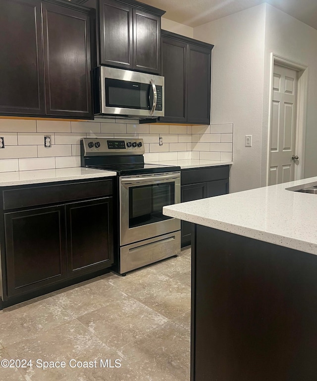 kitchen featuring stainless steel appliances and backsplash