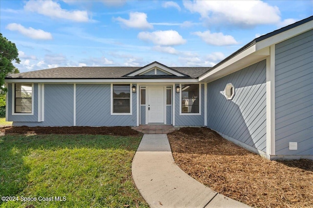 doorway to property featuring a yard