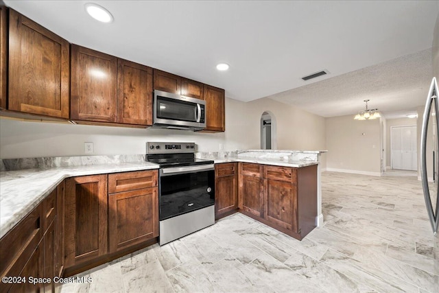 kitchen featuring kitchen peninsula, light stone countertops, a notable chandelier, decorative light fixtures, and appliances with stainless steel finishes