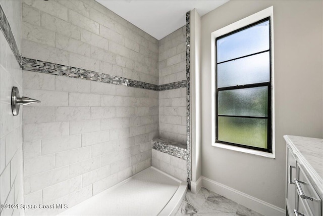 bathroom featuring vanity and a tile shower