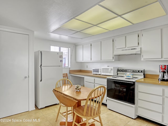 kitchen with white cabinetry, white appliances, and light tile patterned floors