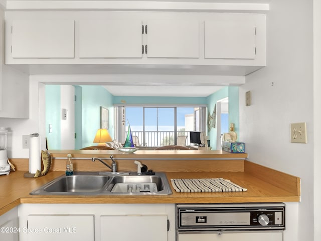 kitchen with white cabinetry and sink