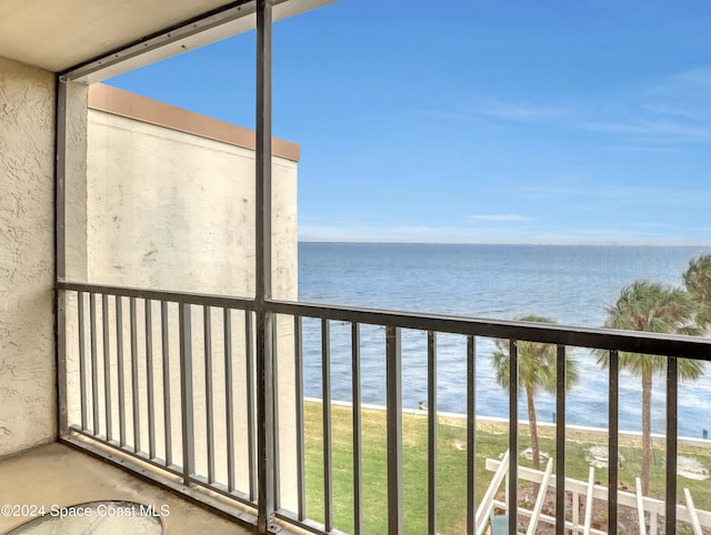 balcony featuring a water view and a beach view