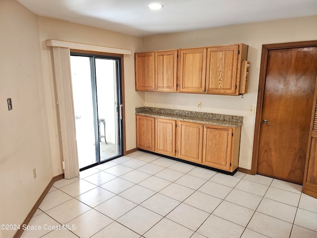 kitchen featuring light stone counters and light tile patterned floors