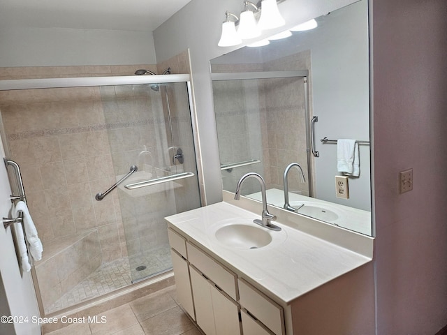 bathroom featuring vanity, a chandelier, tile patterned flooring, and an enclosed shower