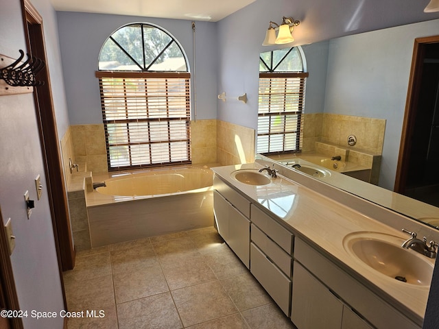 bathroom featuring vanity, tile patterned floors, and tiled tub