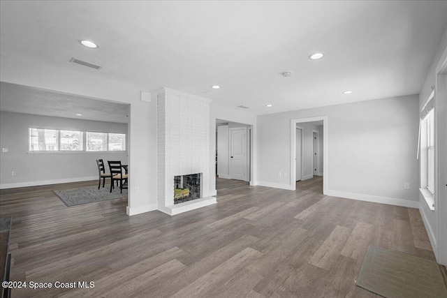 unfurnished living room featuring hardwood / wood-style flooring and a fireplace