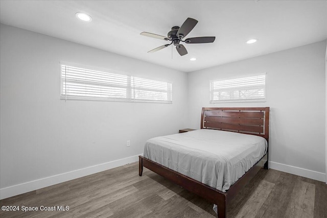 bedroom with dark hardwood / wood-style floors and ceiling fan