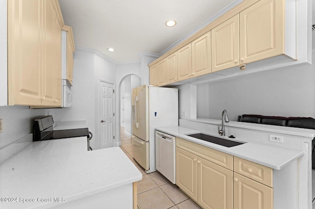 kitchen with ornamental molding, sink, light tile patterned floors, and white appliances