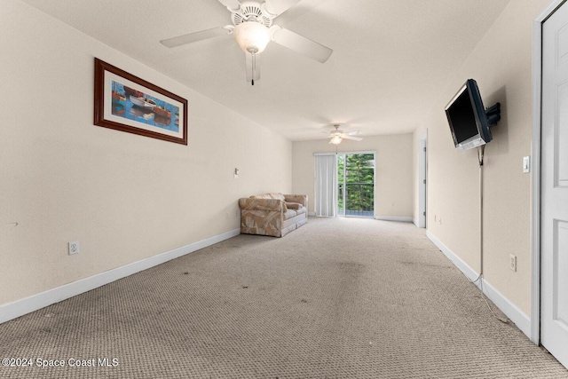 unfurnished room featuring light carpet and ceiling fan