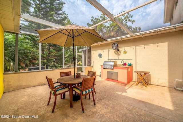 view of patio featuring area for grilling, a lanai, and sink