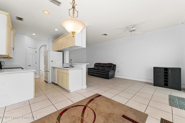 kitchen with ornamental molding, white appliances, sink, and pendant lighting