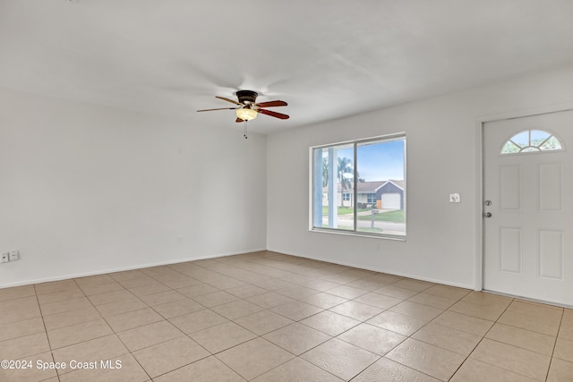 tiled foyer with ceiling fan