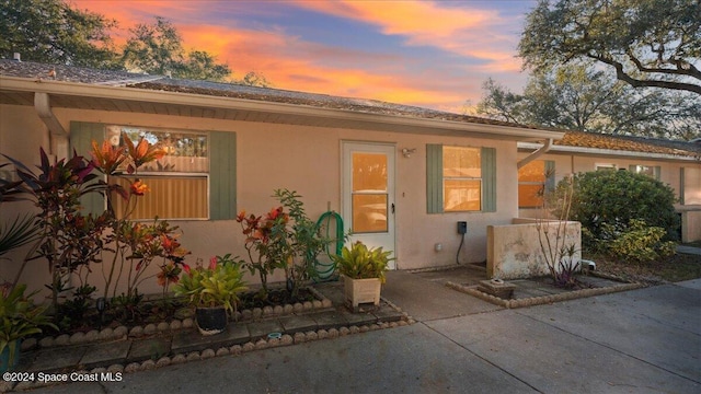 back house at dusk with a patio