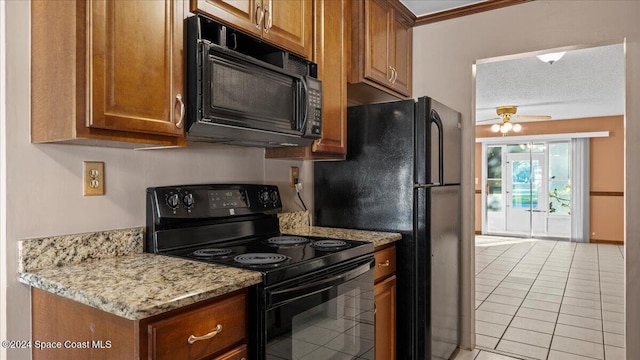 kitchen featuring black appliances, a textured ceiling, ceiling fan, light stone counters, and light tile patterned floors