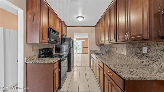 kitchen featuring sink, black appliances, light stone countertops, and light tile patterned flooring