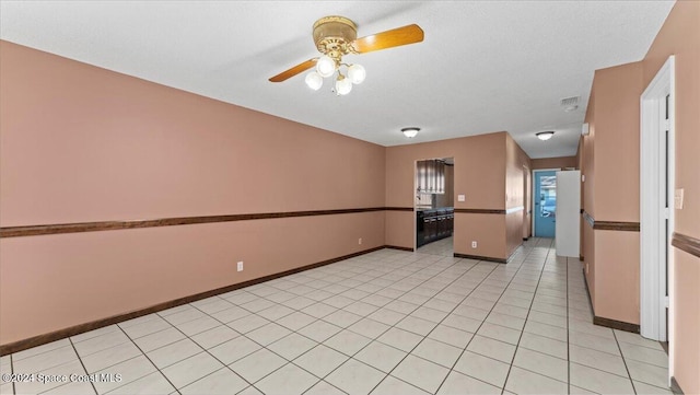 interior space with light tile patterned floors and ceiling fan